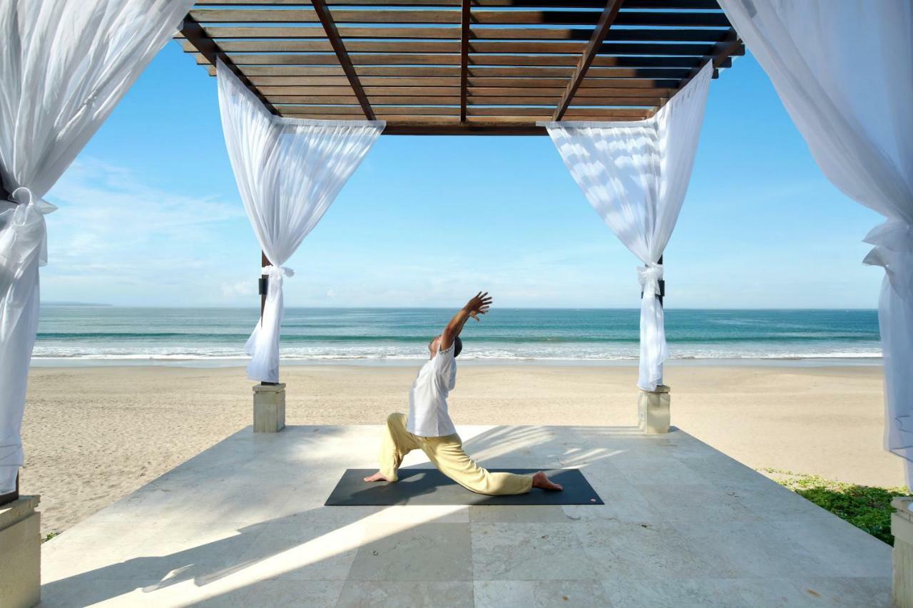 The Seminyak Beach Resort & Spa Εξωτερικό φωτογραφία A man practicing yoga at the beach